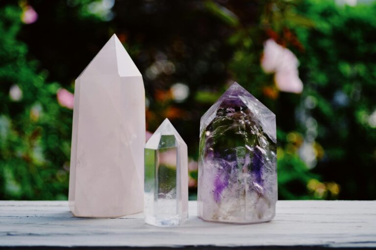 A beautiful arrangement of crystals including amethyst and quartz displayed outdoors.