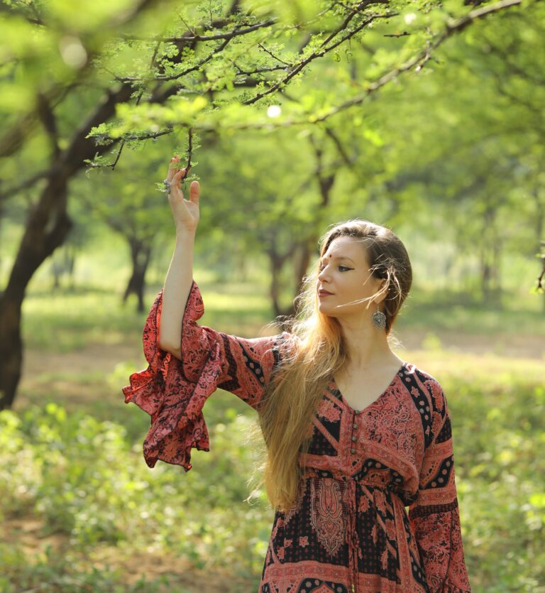 Girl leaning against a tree trunk
