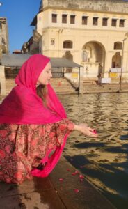Girl placing flowers in water