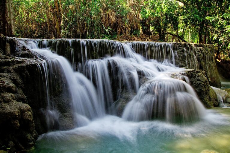 A tranquil waterfall cascading in a lush forest, captured with a long exposure.