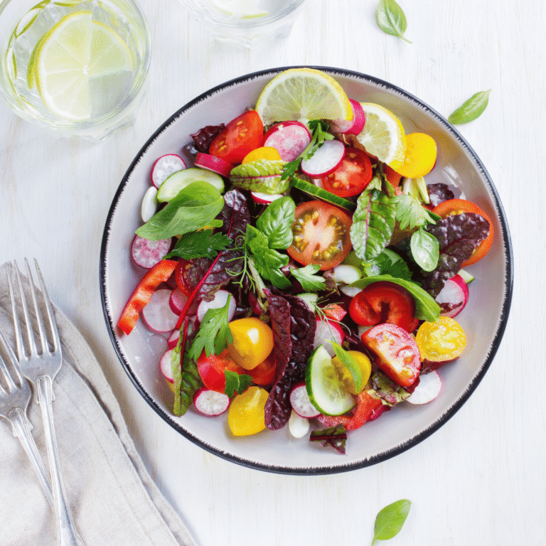 Plate of fresh salad with summer seasonal vegetables and leaves.
