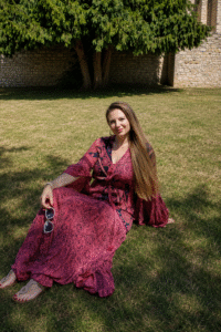 Corinne sitting on grass relaxed grounded and embodied