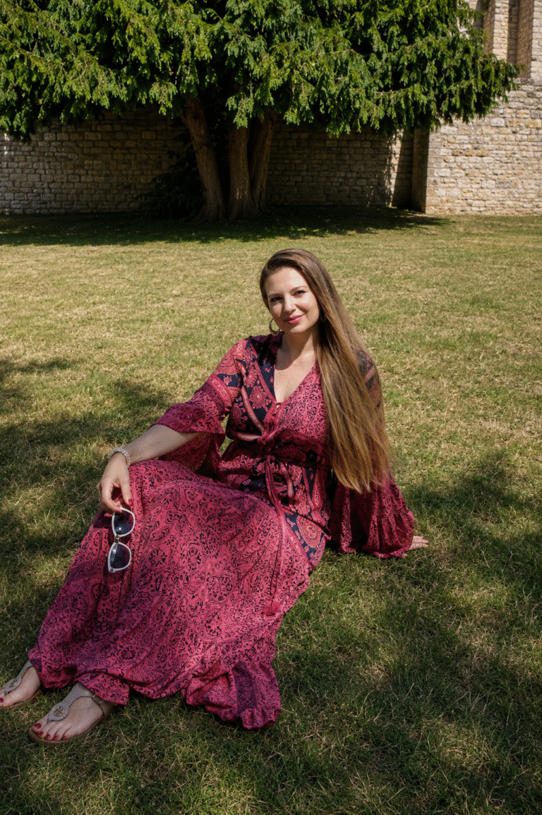 Corinne sitting on grass relaxed grounded and embodied